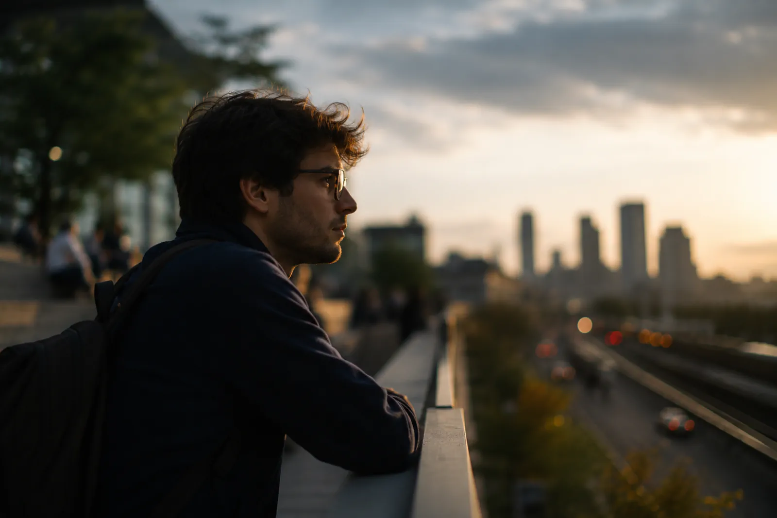 A high-achieving professional looking across a city skyline at dusk while carrying quiet self-doubt