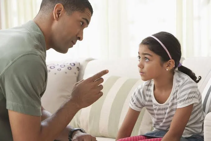A parent and child in a moment of tension, showing the emotional struggle when a child refuses to listen